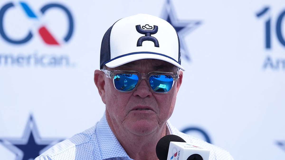 Cowboys executive vice president Stephen Jones speaks into a microphone at the training camp opening press conference