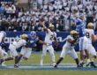 UCF Knights quarterback Tayven Jackson releases a pass under pressure from the BYU defense.