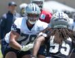 Dallas Cowboys offensive tackle Terence Steele sets in his stance with hands ready as linebacker Jaishawn Barham rushes.