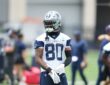 Dallas Cowboys wide receiver Traeshon Holden adjusts his gloves during a minicamp drill in his No. 80 practice jersey.