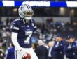 Dallas Cowboys cornerback Trevon Diggs stands with a football in his hand during pregame warmups in a navy No. 7 jersey.