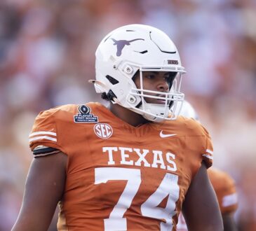 Texas Longhorns offensive lineman Trevor Goosby stands on the field in a burnt orange No. 74 jersey.