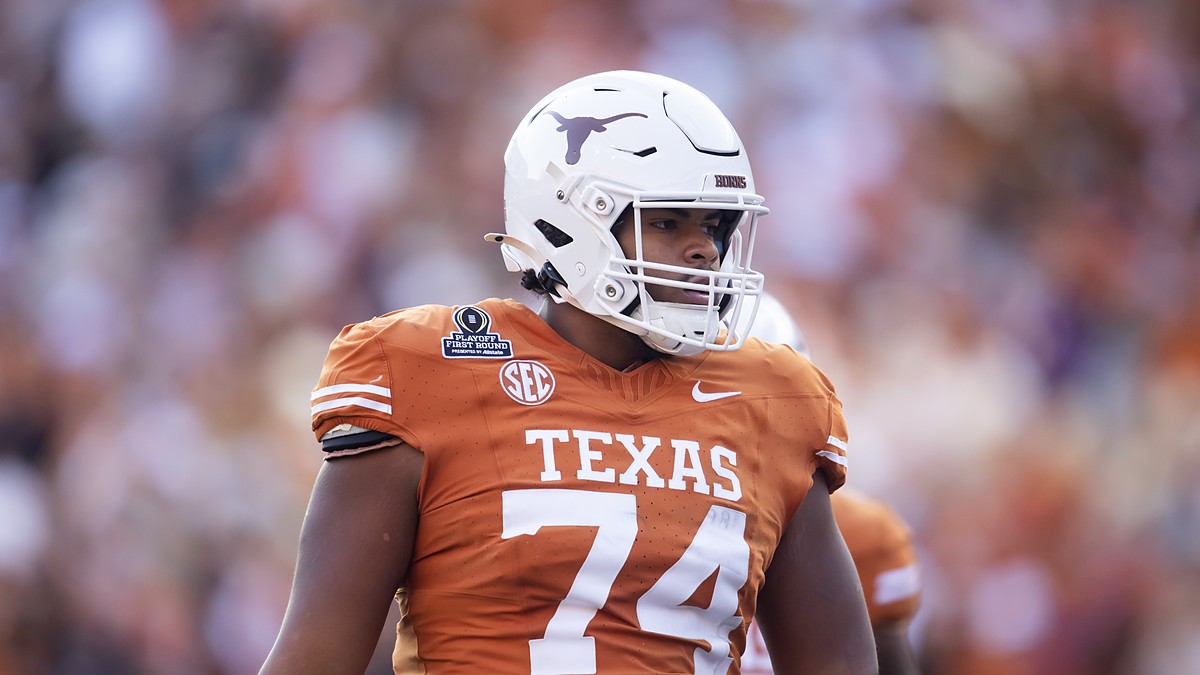 Texas Longhorns offensive lineman Trevor Goosby stands on the field in a burnt orange No. 74 jersey.
