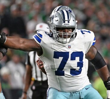 Cowboys guard Tyler Smith extends his arm to block an Eagles defender at the line of scrimmage