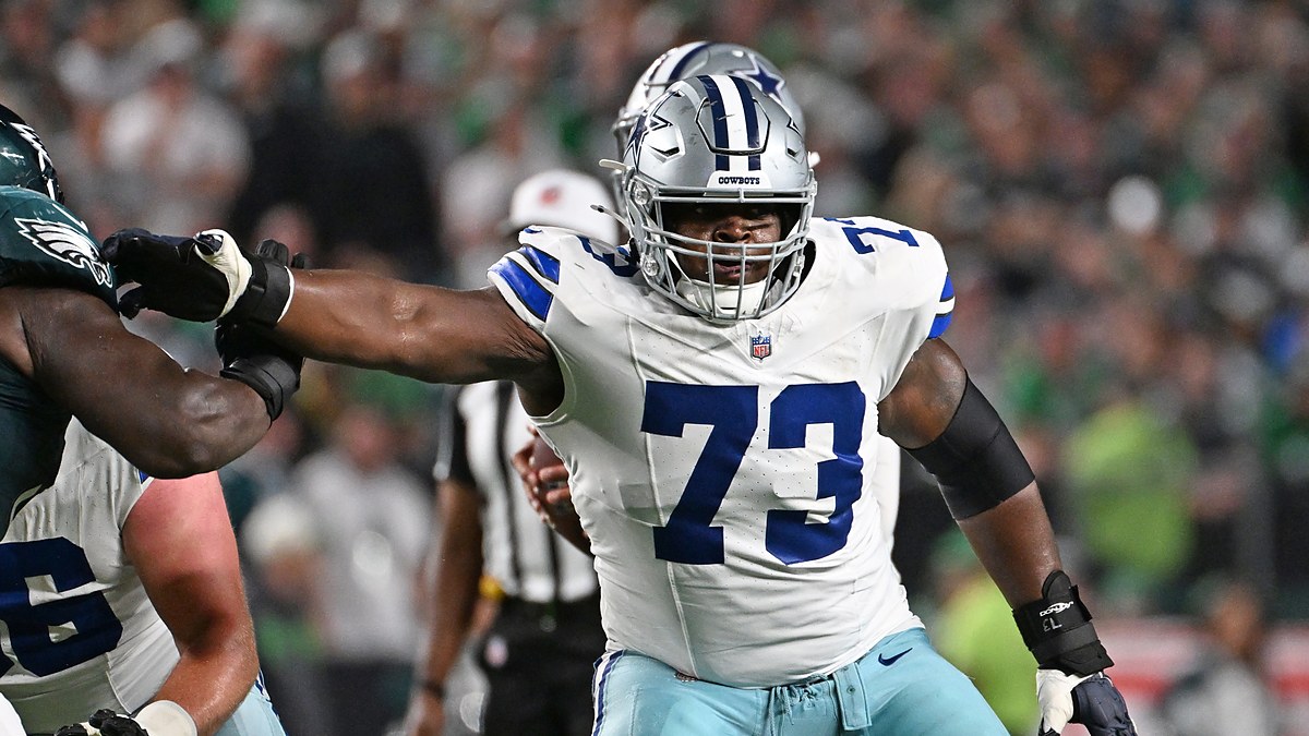 Cowboys guard Tyler Smith extends his arm to block an Eagles defender at the line of scrimmage
