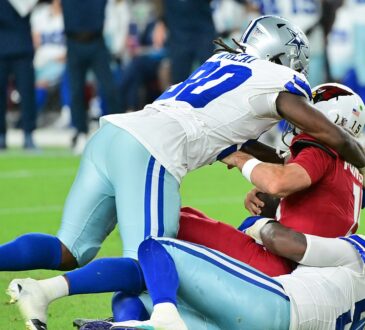 Dallas Cowboys linebacker Tyrus Wheat drives into Arizona Cardinals quarterback Gardner Minshew II as Minshew goes down.