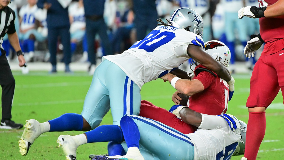 Dallas Cowboys linebacker Tyrus Wheat drives into Arizona Cardinals quarterback Gardner Minshew II as Minshew goes down.