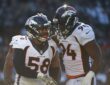 Denver Broncos outside linebacker Von Miller is congratulated by defensive end DeMarcus Ware on the field.