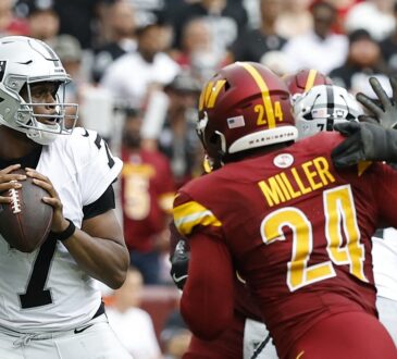 Washington Commanders outside linebacker Von Miller works upfield toward Las Vegas Raiders quarterback Geno Smith as Smith looks to throw.