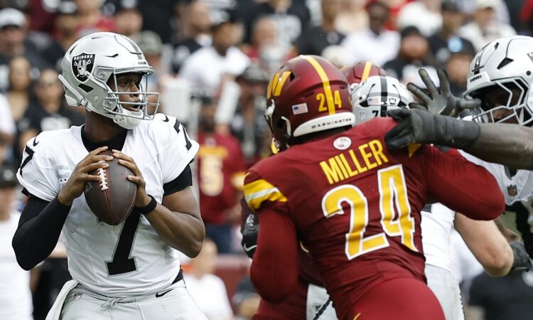 Washington Commanders outside linebacker Von Miller works upfield toward Las Vegas Raiders quarterback Geno Smith as Smith looks to throw.