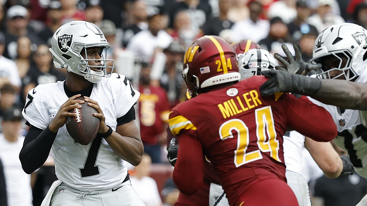 Washington Commanders outside linebacker Von Miller works upfield toward Las Vegas Raiders quarterback Geno Smith as Smith looks to throw.