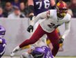 Washington Commanders outside linebacker Von Miller rises after sacking Minnesota Vikings quarterback J.J. McCarthy.