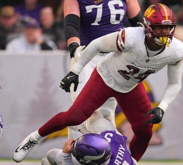 Washington Commanders outside linebacker Von Miller rises after sacking Minnesota Vikings quarterback J.J. McCarthy.