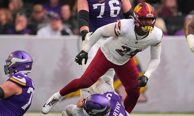 Washington Commanders outside linebacker Von Miller rises after sacking Minnesota Vikings quarterback J.J. McCarthy.
