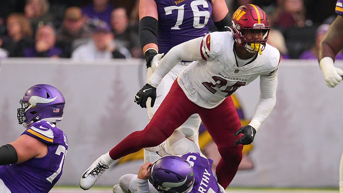Washington Commanders outside linebacker Von Miller rises after sacking Minnesota Vikings quarterback J.J. McCarthy.