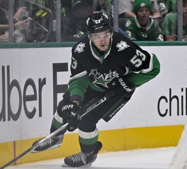 Dallas Stars center Wyatt Johnston skates with the puck along the boards at American Airlines Center.