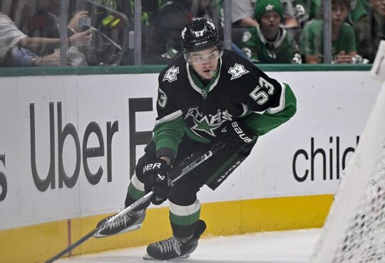 Dallas Stars center Wyatt Johnston skates with the puck along the boards at American Airlines Center.