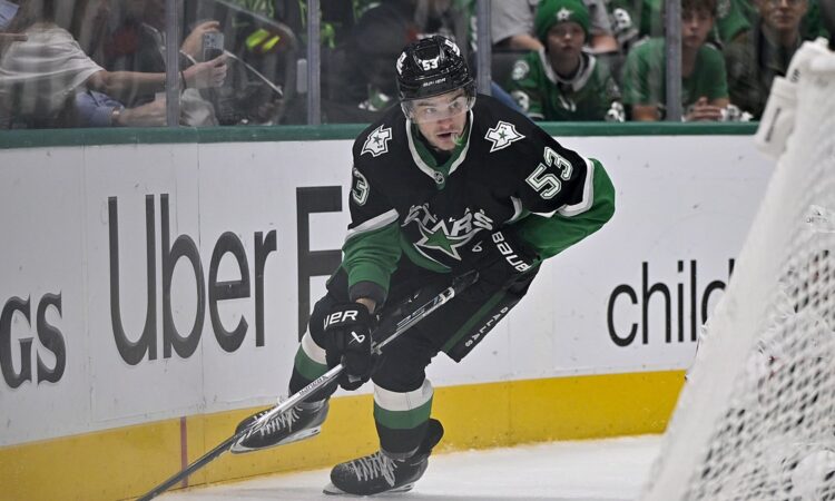 Dallas Stars center Wyatt Johnston skates with the puck along the boards at American Airlines Center.