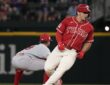Texas Rangers left fielder Wyatt Langford rounds second in a red Tejas jersey as an Angels infielder crouches nearby.