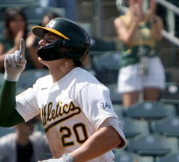 Athletics left fielder Zack Gelof raises an index finger as he runs home after a two-run home run.