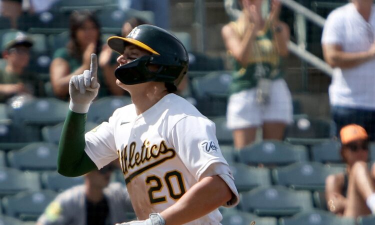 Athletics left fielder Zack Gelof raises an index finger as he runs home after a two-run home run.