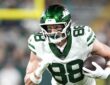 New York Jets tight end Zack Kuntz carries the football upfield after a catch at Lambeau Field.