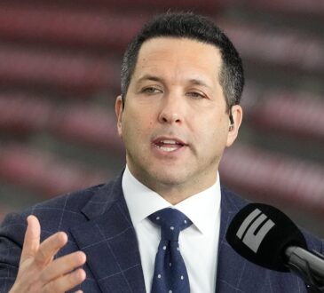 ESPN reporter Adam Schefter speaks on a broadcast set before a college football game at NRG Stadium.