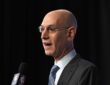 NBA commissioner Adam Silver speaks into an NBA-branded microphone at a press conference.