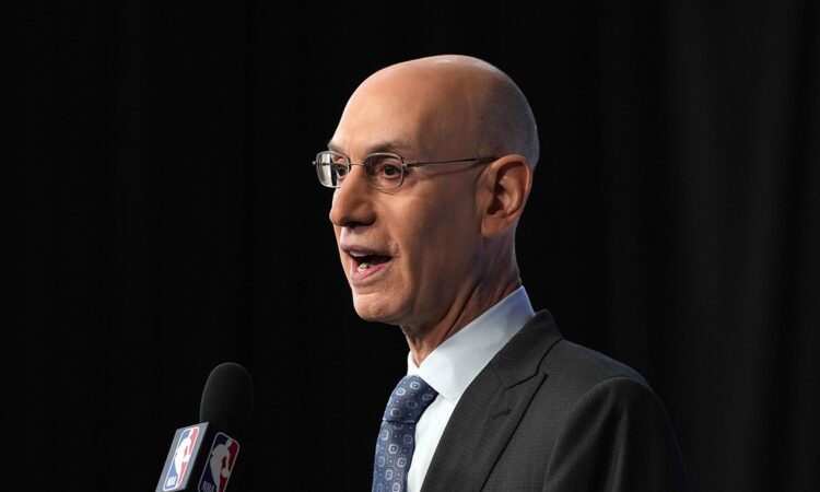 NBA commissioner Adam Silver speaks into an NBA-branded microphone at a press conference.