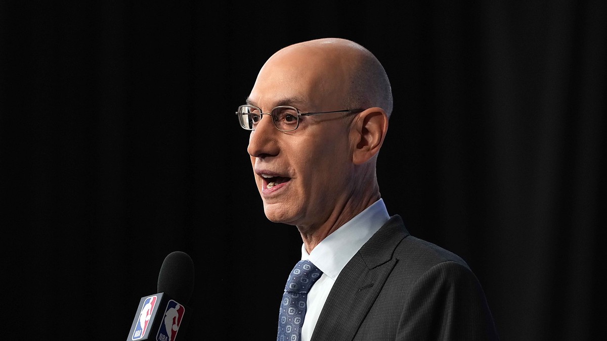 NBA commissioner Adam Silver speaks into an NBA-branded microphone at a press conference.
