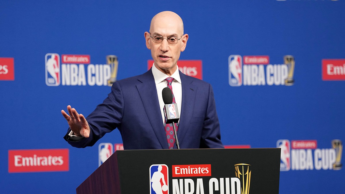 NBA commissioner Adam Silver gestures with one hand while speaking at an NBA Cup podium.