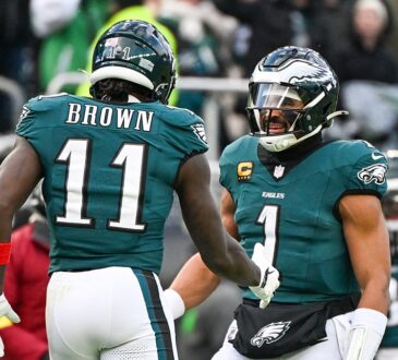 Philadelphia Eagles wide receiver A.J. Brown and quarterback Jalen Hurts celebrate on the field at Lincoln Financial Field.