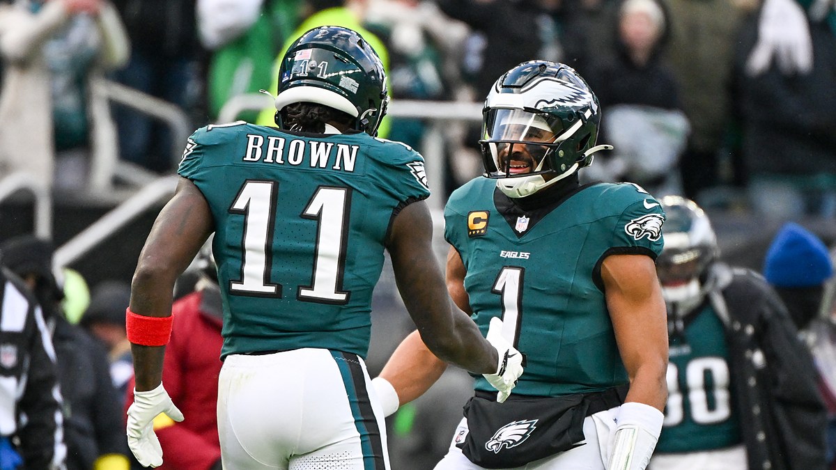 Philadelphia Eagles wide receiver A.J. Brown and quarterback Jalen Hurts celebrate on the field at Lincoln Financial Field.