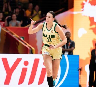 Australia forward Alanna Smith, No. 11, points downcourt while running back after a basket.