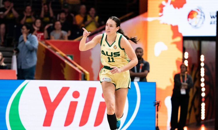 Australia forward Alanna Smith, No. 11, points downcourt while running back after a basket.