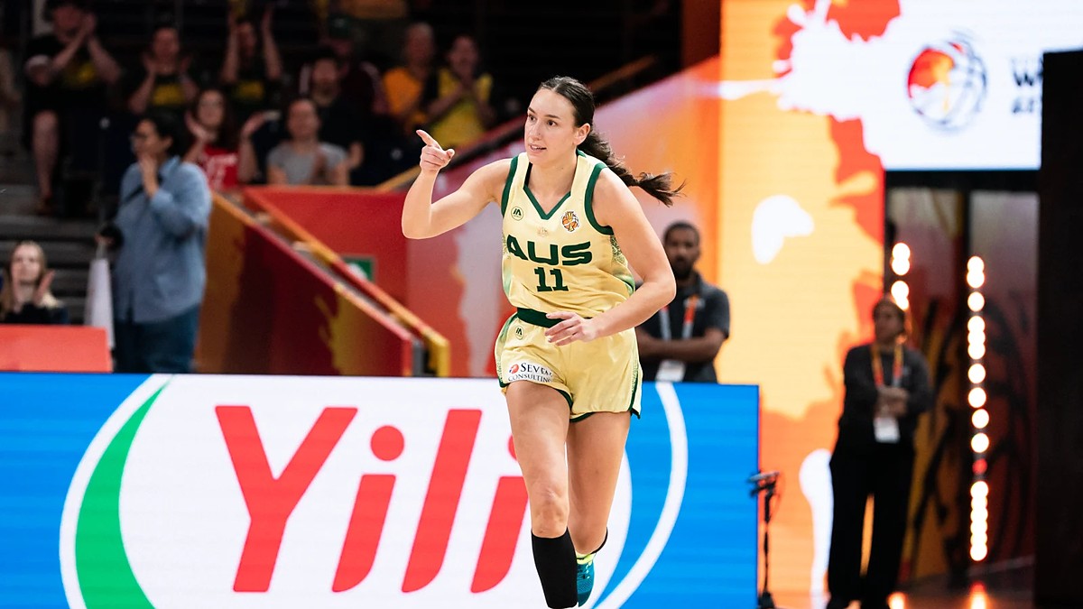 Australia forward Alanna Smith, No. 11, points downcourt while running back after a basket.