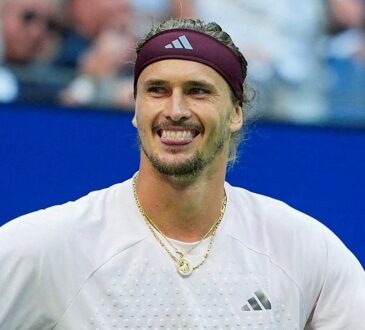 Alexander Zverev of Germany grins with his arms spread after winning a match.