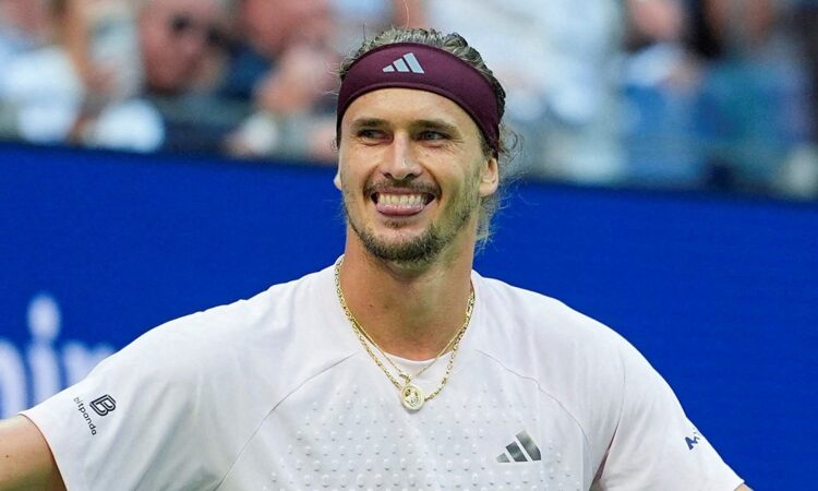 Alexander Zverev of Germany grins with his arms spread after winning a match.
