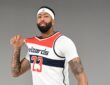Washington Wizards forward and center Anthony Davis tugs on his No. 23 white home jersey while posing for a portrait.