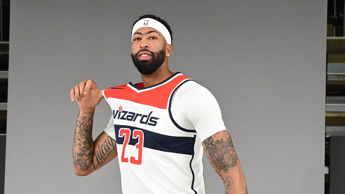 Washington Wizards forward and center Anthony Davis tugs on his No. 23 white home jersey while posing for a portrait.