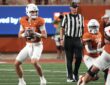 Texas Longhorns quarterback Arch Manning holds the ball at his chest and scans downfield against Ohio State.