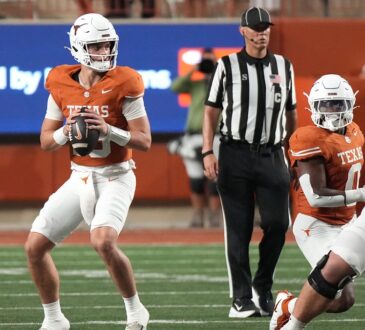 Texas Longhorns quarterback Arch Manning holds the ball at his chest and scans downfield against Ohio State.