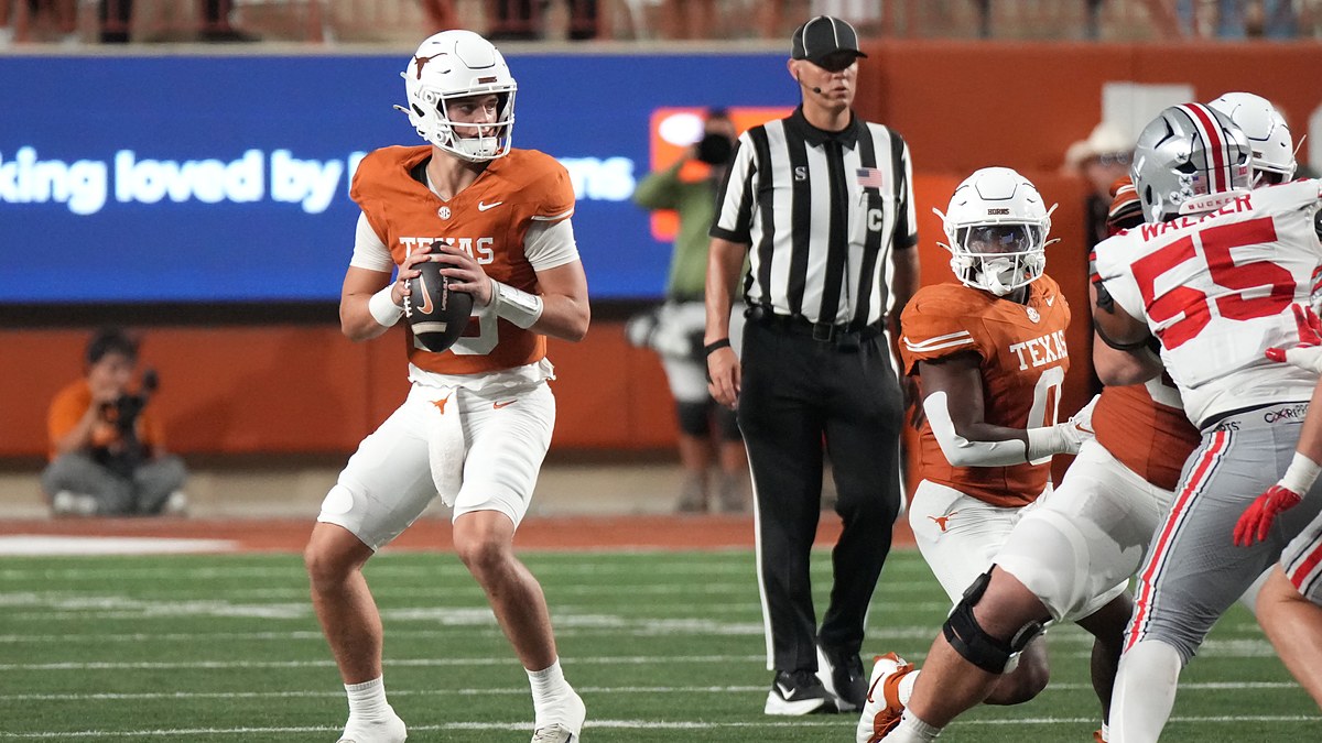 Texas Longhorns quarterback Arch Manning holds the ball at his chest and scans downfield against Ohio State.