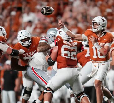 Texas Longhorns quarterback Arch Manning releases a pass from the pocket as linemen block against Ohio State.