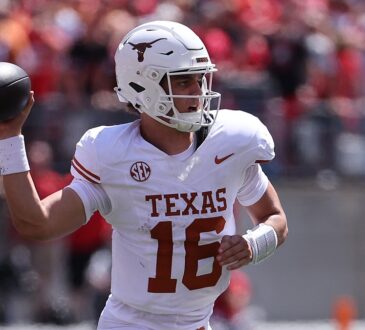 Texas Longhorns quarterback Arch Manning drops back with the ball cocked to throw against Ohio State.