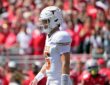 Texas Longhorns quarterback Arch Manning walks back toward the huddle in front of the Ohio State crowd.