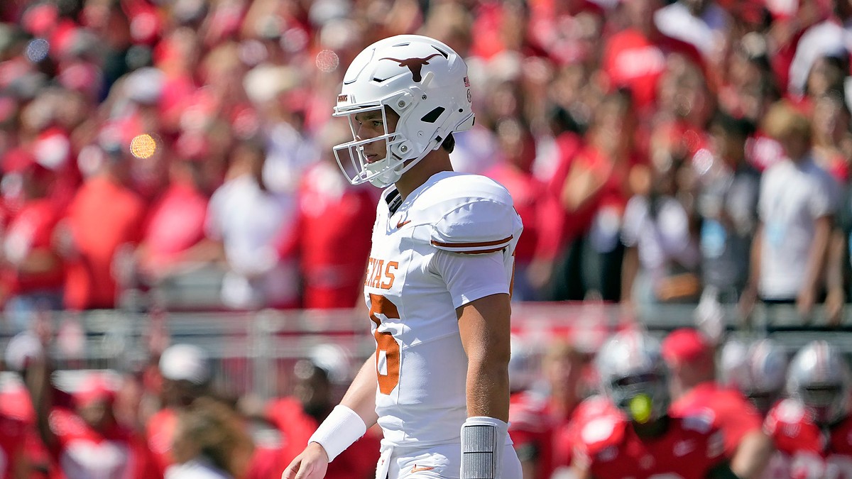 Texas Longhorns quarterback Arch Manning walks back toward the huddle in front of the Ohio State crowd.