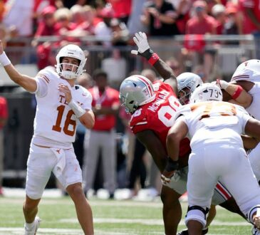Texas Longhorns quarterback Arch Manning releases a pass as the pocket collapses around him against Ohio State.
