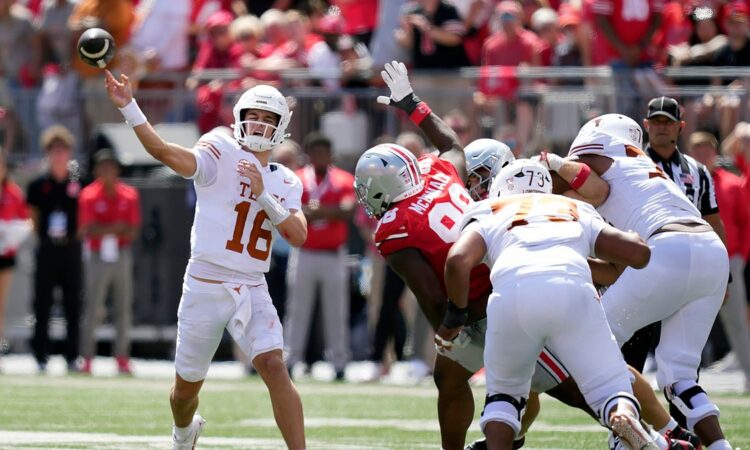 Texas Longhorns quarterback Arch Manning releases a pass as the pocket collapses around him against Ohio State.