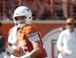 Texas Longhorns quarterback Arch Manning, No. 16, brings the ball back and looks downfield.